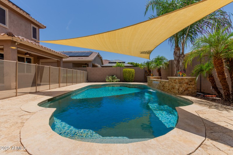 Serene Waterfall Shaded Pebbletec Pool