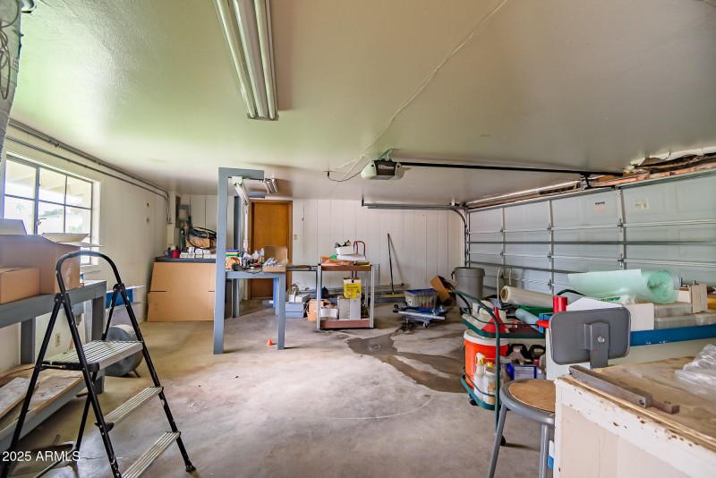Two car garage with multiple storage roo