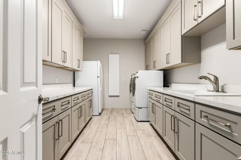 Basement laundry room with storage