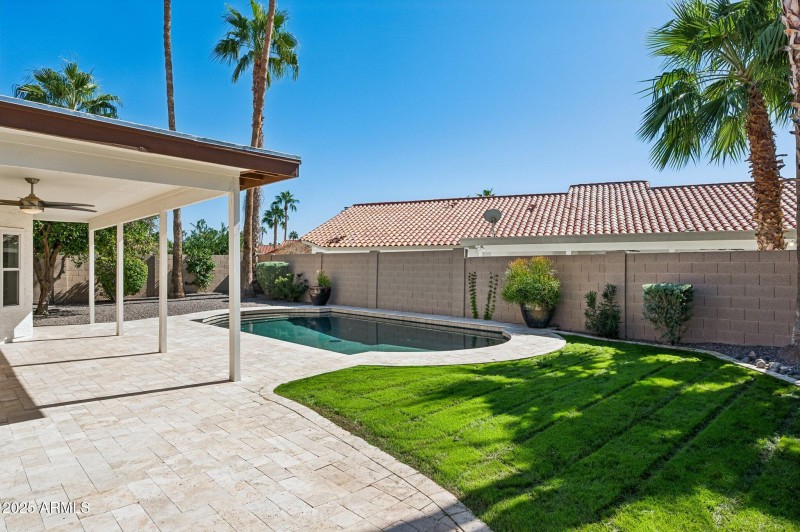 Private backyard with lush green lawn
