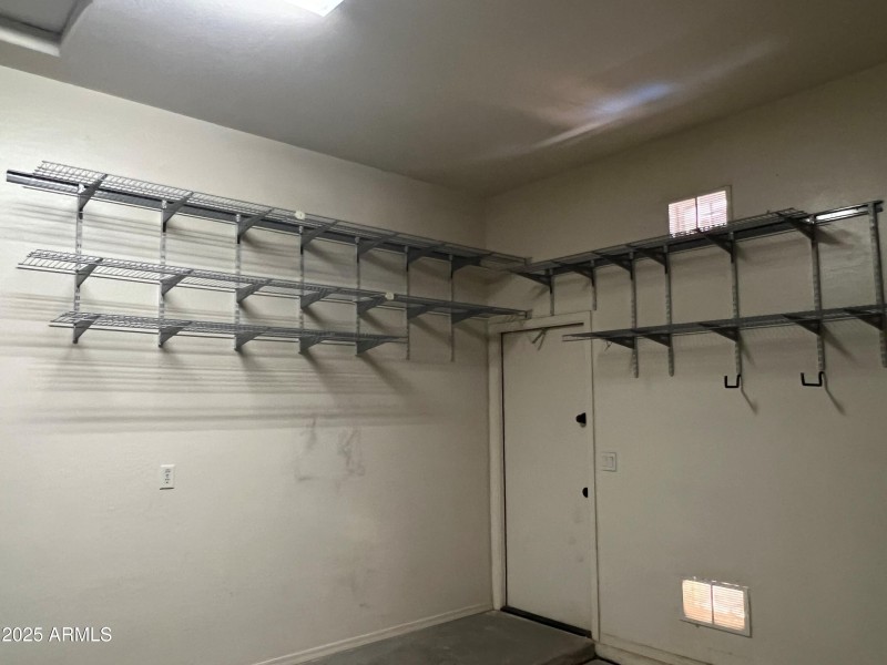 Garage with service door and shelving