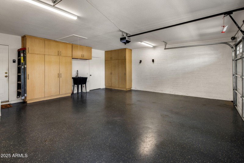 Garage with Cabinets + Storage Room