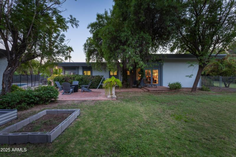 Back of home w/ garden beds