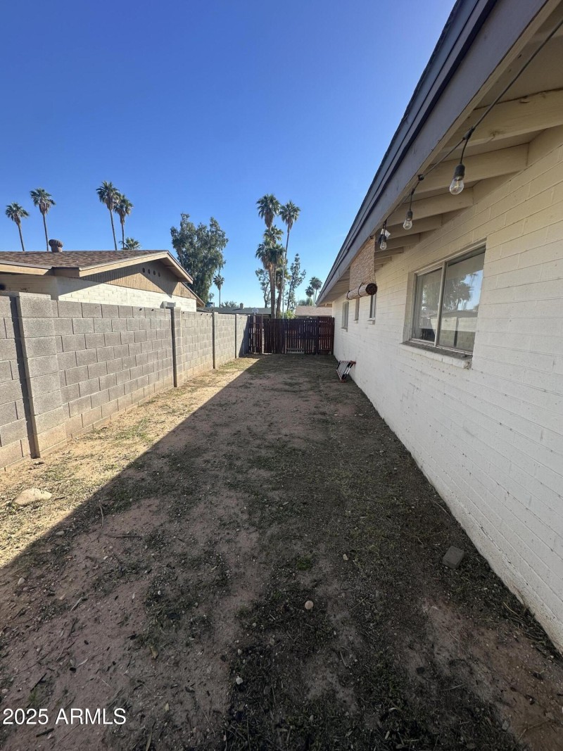 long view of side yard with RV gate