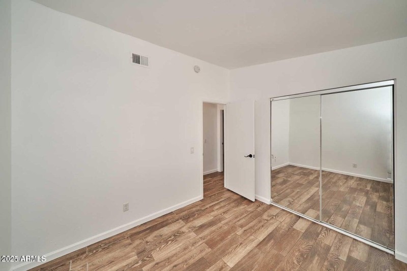 Guest bedroom with mirrored closet