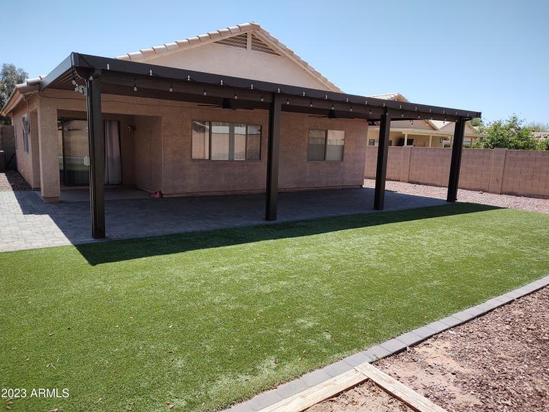 Large backyard with covered patio