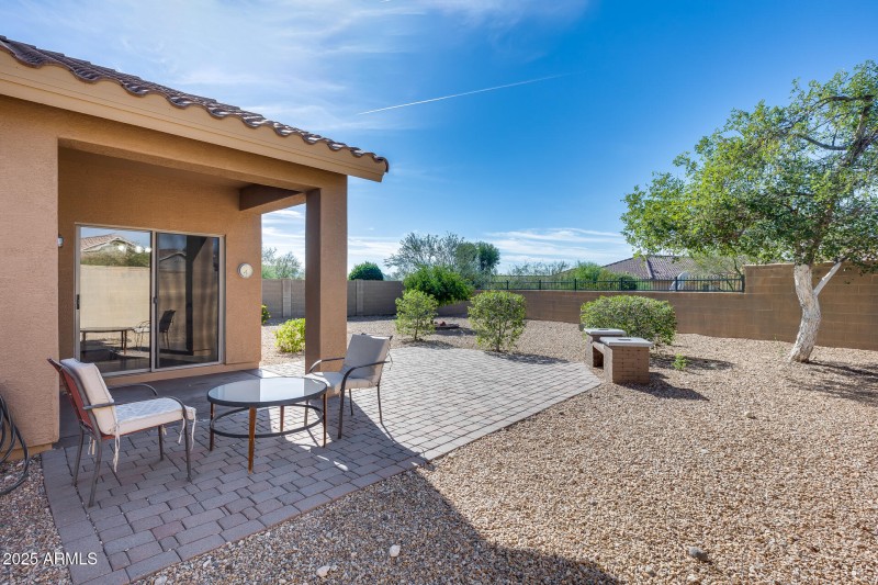 Covered patio and yard with view fence