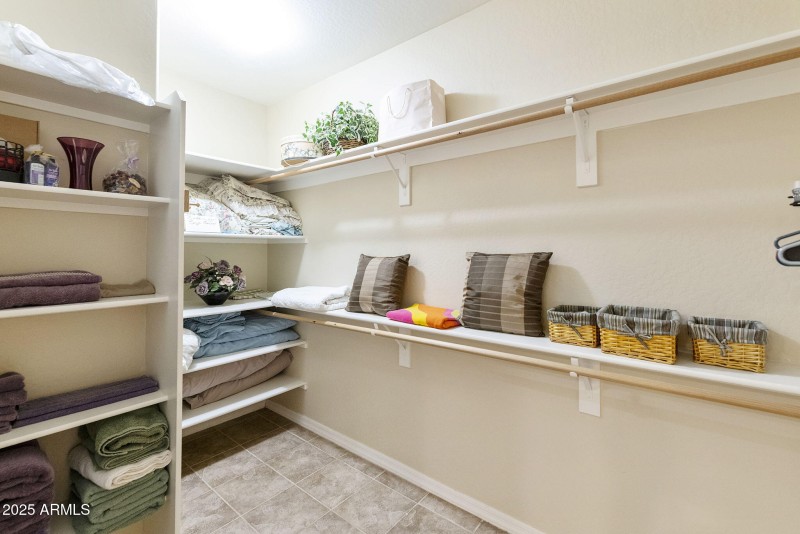 primary walk in closet with linens