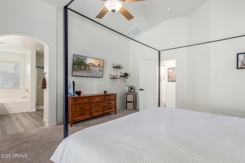 Primary bedroom with entry to bathroom