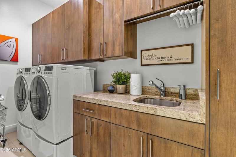 Spacious Laundry w sink & storage.