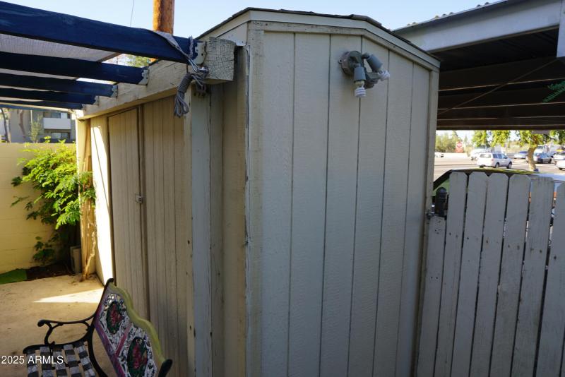 Storage unit by carport in back