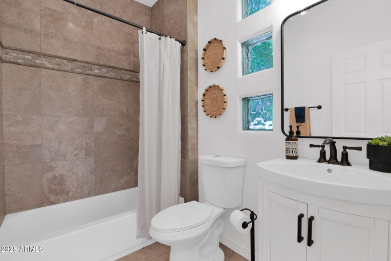 one of two full baths downstairs