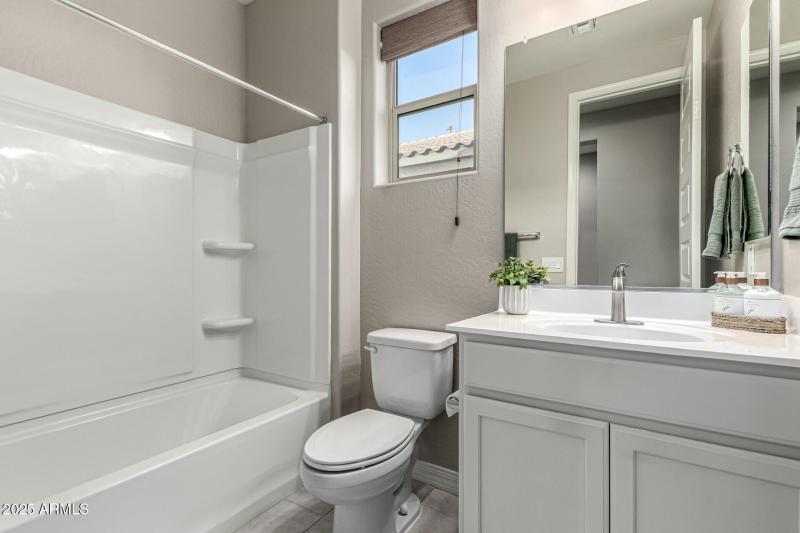 Hall bathroom with shower over tub