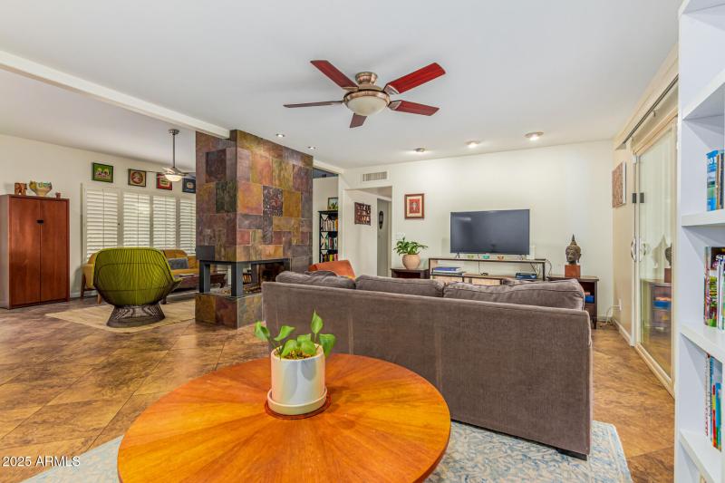Living area w/2 sided stone fireplace.