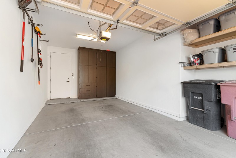 Garage with built in cabinets & shelving