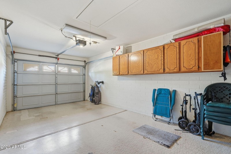 Garage with cabinetry.