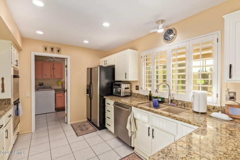 Kitchen overlooks patio and the course