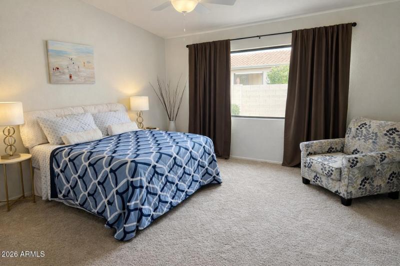 Bright and cozy bedroom with beach artwo