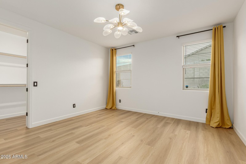 Primary bedroom with view of backyard
