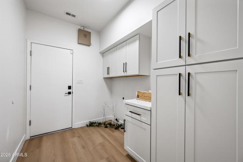 Indoor Laundry Room with Cabinets