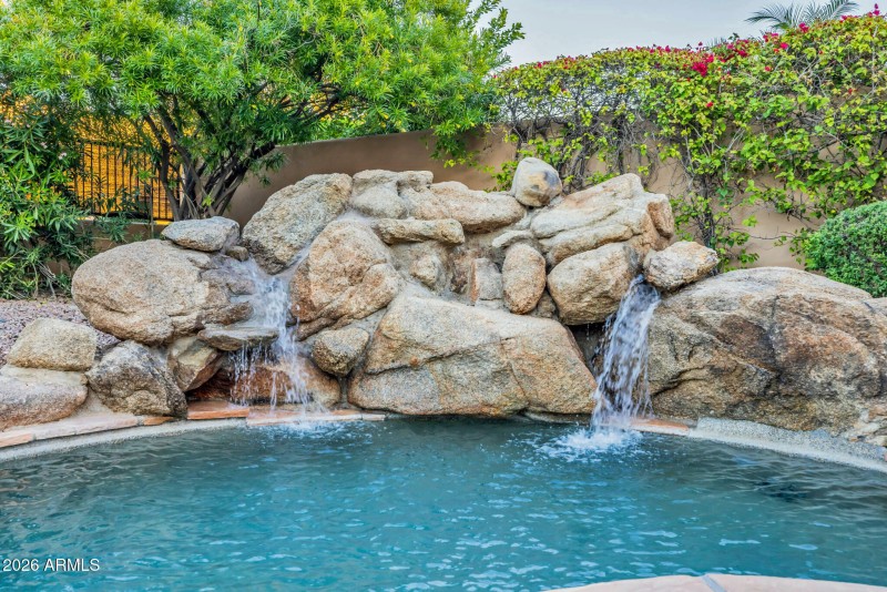 WATERFALL CASCADING INTO POOL