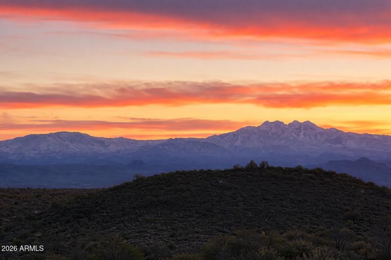 Sunset over desert and snowy peaks