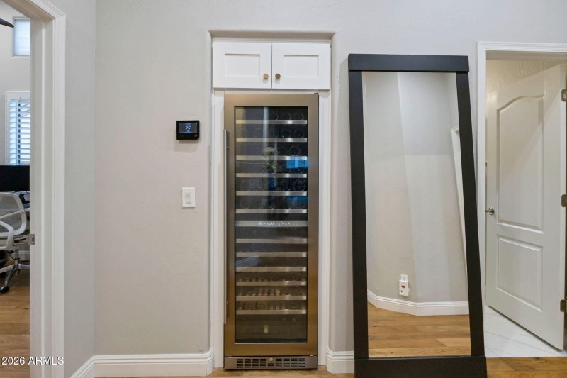 Hallway linen converted to wine storage.