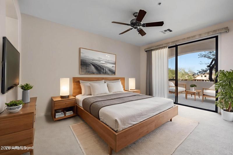 Spacious master bedroom with covered pat