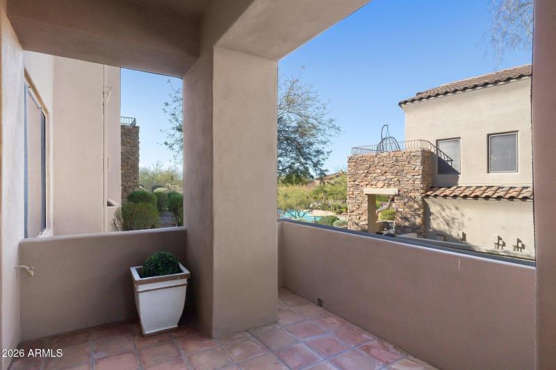 One of two tiled patios with pool & suns