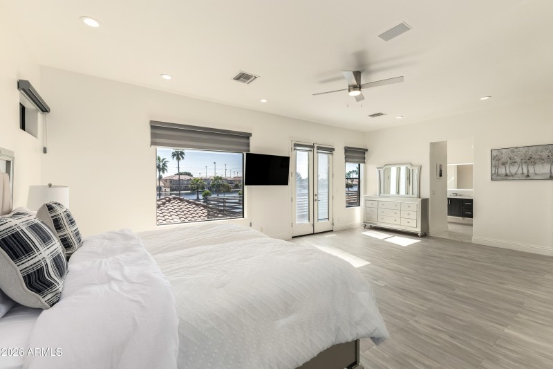 Upstairs primary bedroom with balcony