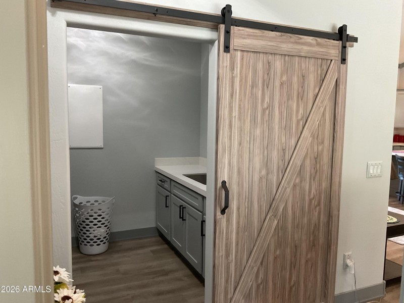 Barn door covers laundry room.