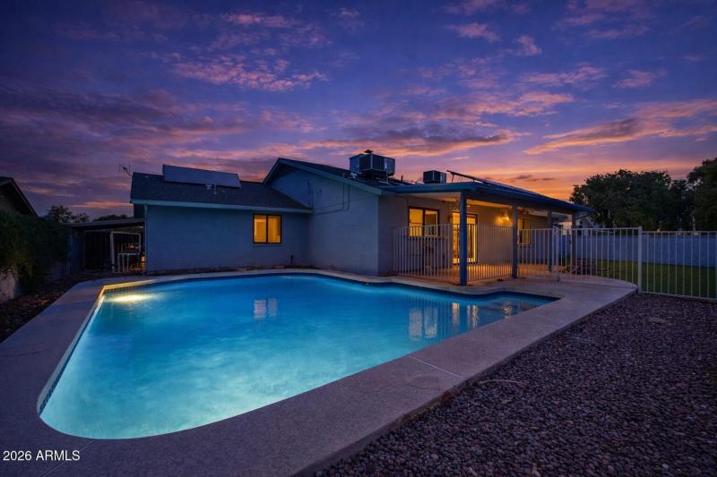 Twilight pool glow in suburban backyard