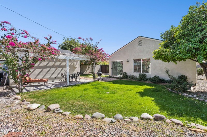 Rear yard features natural grass