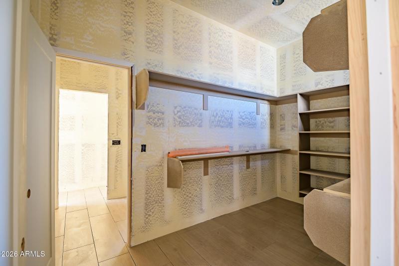 Master closet with door to laundry room