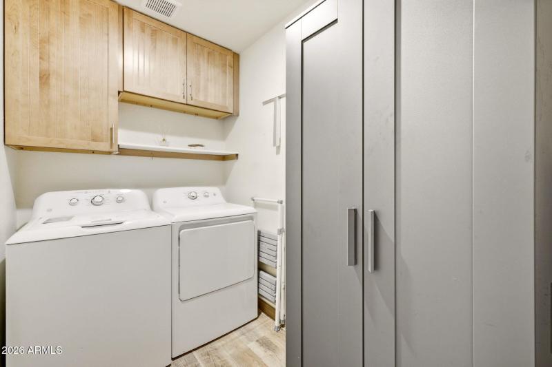 Inside laundry with storage