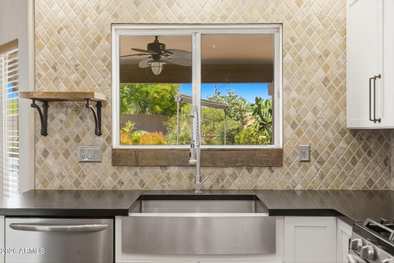 Farmhouse sink overlooking backyard