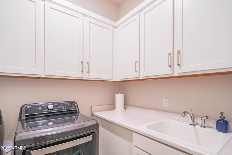 Laundry room with sink and storage
