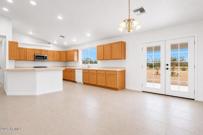 vacant open concept kitchen and dining r