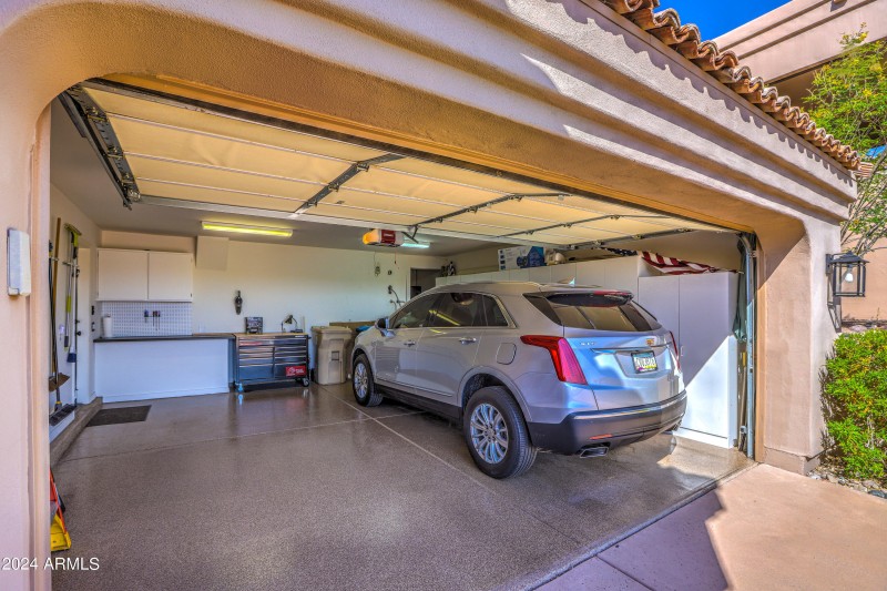 spacious garage with cabinets and epoxy