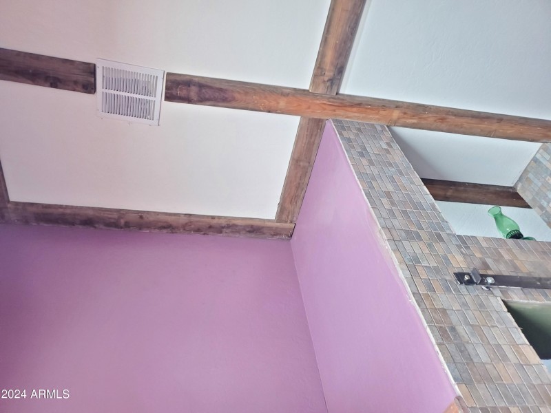 wood-rimmed ceiling in master bathroom