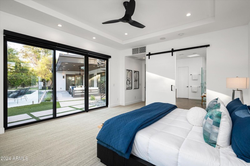 Master bedroom with view out to backyard