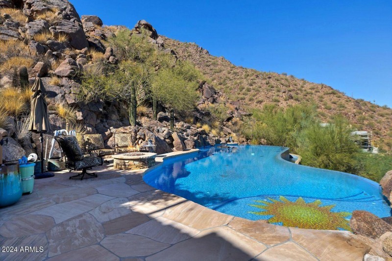 Boulders Appear to Spill into the Pool