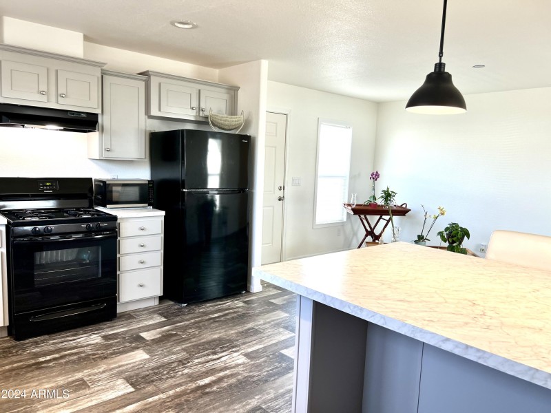 VIEW FROM KITCHEN TO LIVING AND EXIT