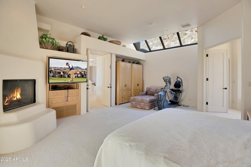 12 Primary suite with fireplace and moun
