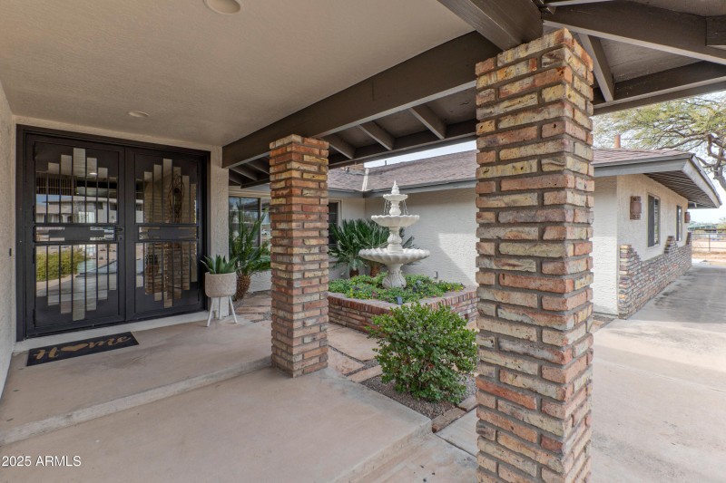 Covered entry with new double iron doors