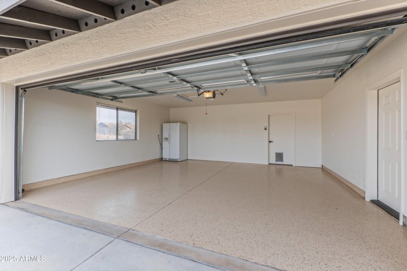 Garage with epoxy floor and spare fridge