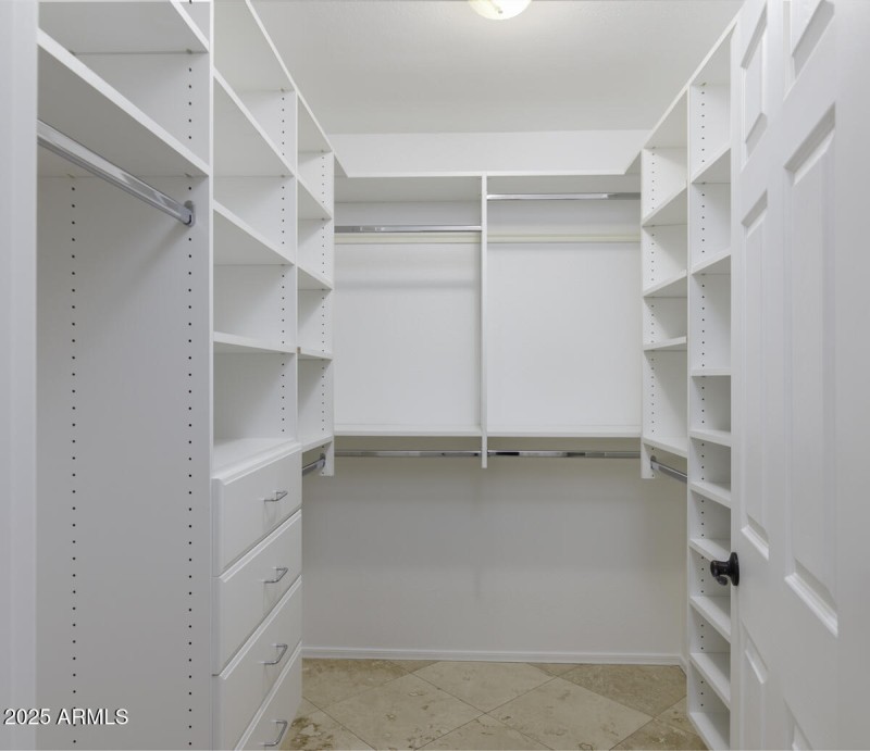 Primary bedroom walk-in closet