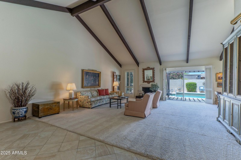Living room overlooks patio and pool