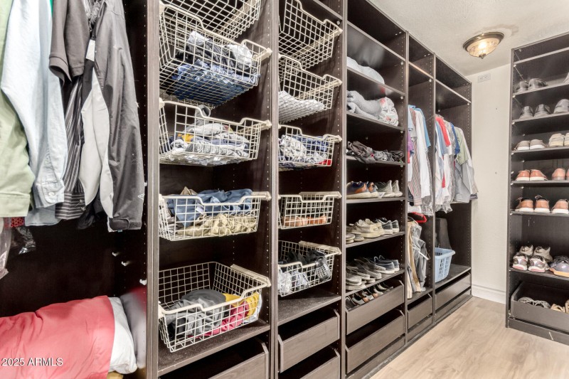 Primary walk-in closet with organizers