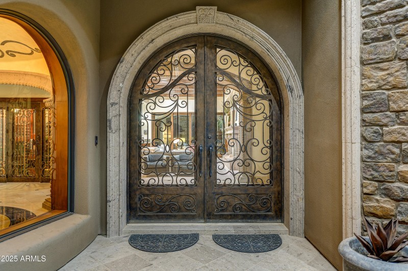 Grand Iron & Stone Entry Doors